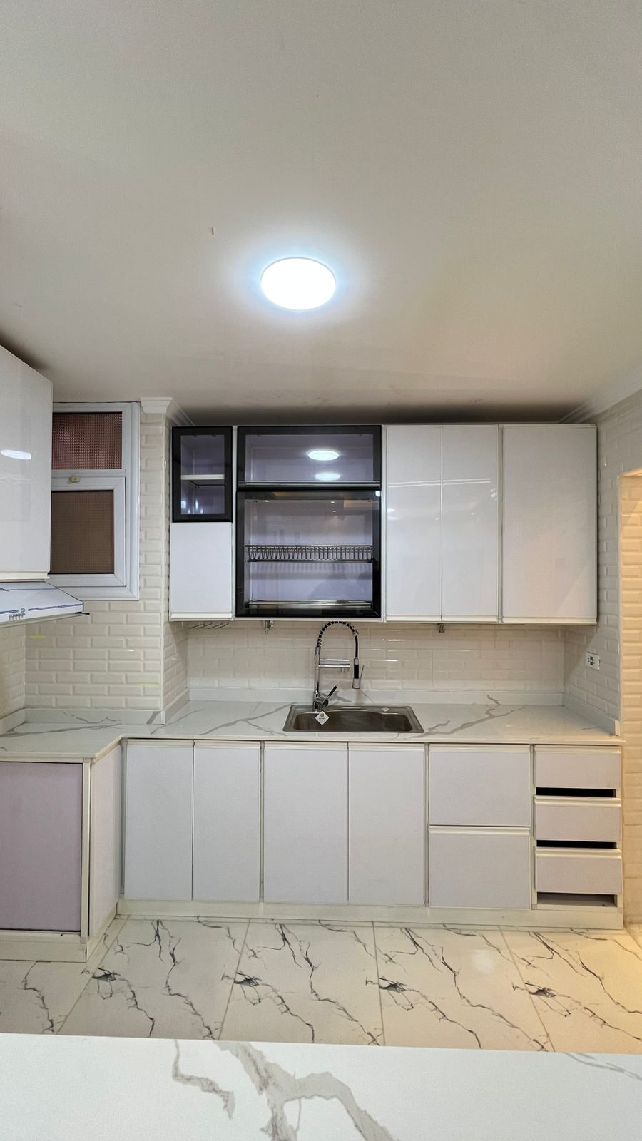 Warm camel kitchen cabinets with light-colored marble