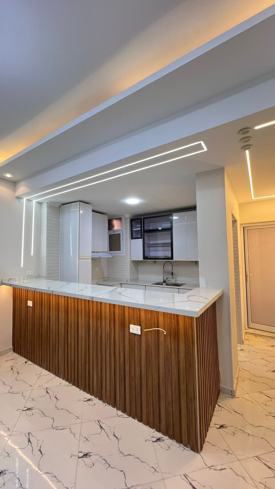 Large single stainless steel kitchen sink installed in an aluminum counter