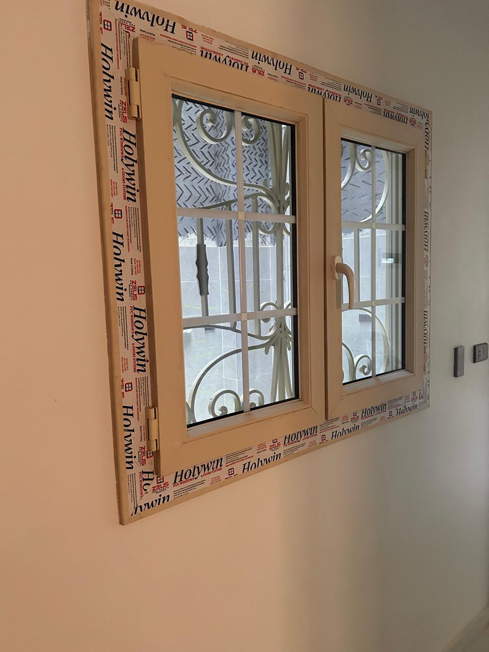 Egyptian PVC windows bringing natural light into an olive green kitchen